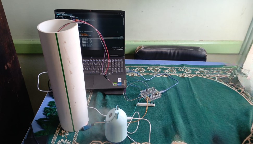 Air Clarity Silica System prototype with pipe filter, Arduino sensor, and laptop showing monitoring data