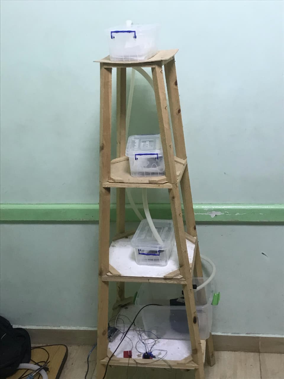 Tri-aqua Revive System prototype showing the multi-stage water purification setup with wooden frame structure